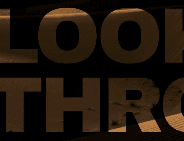 Hero section featuring bold typography with a video revealing through a knockout window effect
